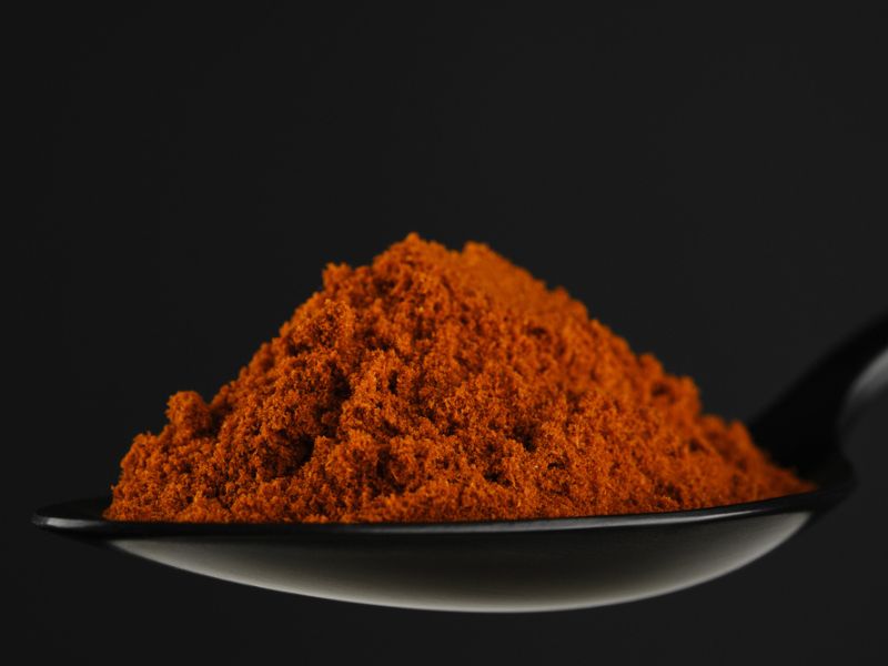 Smoked paprika in a black spoon