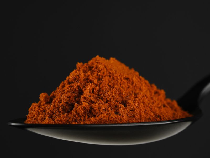 Smoked paprika on a black spoon